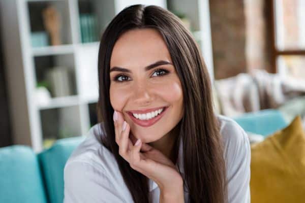 Woman smiling confidently after orthodontic treatment in Asheboro, NC