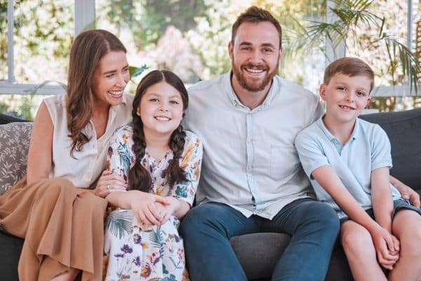Family smiling together outside orthodontic office in Asheboro, NC